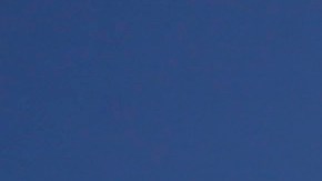 In this photo taken with a fisheye lens, Merissa Rocha, left, of Anaheim Calif., and Celso Arreola, of Los Angeles, plant their beach umbrella on the sand in an effort to avoid the ongoing southern California heat wave, Monday, Sept. 15, 2014, in Huntington Beach, Calif. Southern California is roasting in triple-digit temperatures and forecasters say the heat wave will continue at least another day. (AP Photo/Chris Carlson)