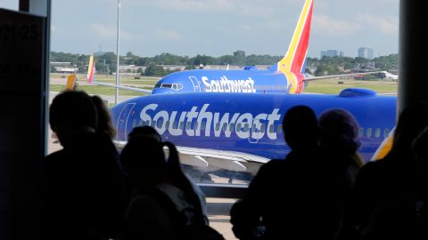 Southwest passengers and airliners line up and move at Love Field in Dallas, Thursday, July 25, 2024. Southwest Airlines said Thursday that it plans to drop the open-boarding system it has used for more than 50 years and will start assigning passengers to seats, just like all the other big airlines. (AP Photo/LM Otero)