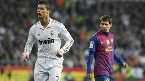 Real Madrid's Cristiano Ronaldo from Portugal, left, runs beside FC Barcelona's Lionel Messi from Argentina, right, during their quarter finals, first leg, Copa del Rey soccer match at the Santiago Bernabeu stadium in Madrid, Spain, Wednesday, Jan. 18, 2012. (AP Photo/Andres Kudacki)