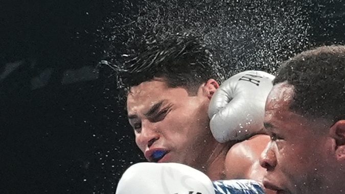 Devin Haney, right, punches Ryan Garcia during the 12th round of a super lightweight boxing match early Sunday, April 21, 2024, in New York. (AP Photo/Frank Franklin II)