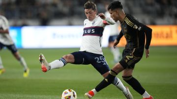 Vancouver Whitecaps midfielder Ryan Gauld (25) and Los Angeles FC defender Omar Campos (2) reach for the ball during the first half of an MLS soccer match in Los Angeles, Saturday, May 11, 2024. (AP Photo/Ashley Landis)