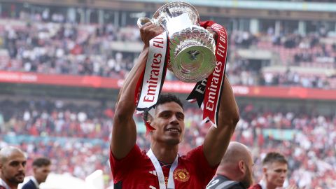 Manchester United's Raphael Varane celebrates with the trophy after winning the English FA Cup final soccer match between Manchester City and Manchester United at Wembley Stadium in London, Saturday, May 25, 2024. (AP Photo/Ian Walton)