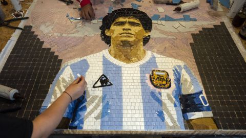 Artists construct a tile mosaic of soccer legend Diego Maradona during a celebration marking the anniversary of the “Hand of God” goal and the “Goal of the Century” scored by Maradona against England during the 1986 World Cup quarterfinals, in Buenos Aires, Argentina, Saturday, June 22, 2024. Maradona, who died in 2020 at age 60, captained Argentina in its 3-2 win over West Germany in the 1986 final in Mexico City. (AP Photo/Rodrigo Abd)