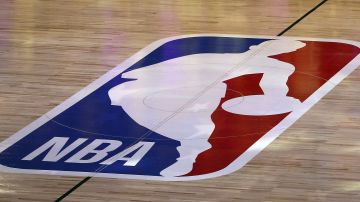 FILE - An NBA logo is seen at center court prior to an NBA basketball game between the Los Angeles Clippers and the Los Angeles Lakers, Thursday, July 30, 2020, in Lake Buena Vista, Fla. The NBA has agreed to terms on its new media deal, an 11-year agreement worth $76 billion that assures player salaries will continue rising for the foreseeable future and one that will surely change how some viewers access the game for years to come. (Mike Ehrmann/Getty Images via AP, Pool, File)