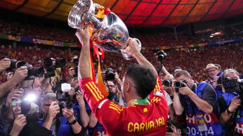 Spain's Dani Carvajal holds up the trophy to the fans after winning the final match between Spain and England at the Euro 2024 soccer tournament in Berlin, Germany, Sunday, July 14, 2024. Spain won 2-1. (AP Photo/Manu Fernandez)