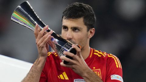 Spain's Rodri kisses his Best Player of the tournament trophy after the final match between Spain and England at the Euro 2024 soccer tournament in Berlin, Germany, Sunday, July 14, 2024. Spain won 2-1. (AP Photo/Manu Fernandez)