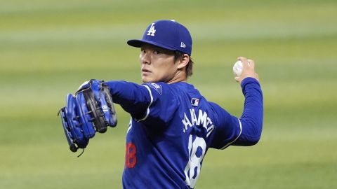 Injured Los Angeles Dodgers starting pitcher Yoshinobu Yamamoto, of Japan, warms up prior to a baseball game against the Arizona Diamondbacks, Sunday, Sept. 1, 2024, in Phoenix. (AP Photo/Ross D. Franklin)