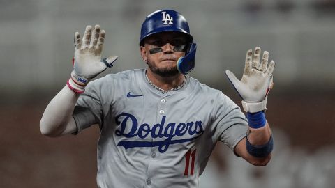 Los Angeles Dodgers' Miguel Rojas (11) celebrates his solo homer against the Atlanta Braves in the third inning of a baseball game, Friday, Sept. 13, 2024, in Atlanta. (AP Photo/Mike Stewart)