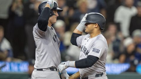 New York Yankees' Jasson Dominguez, right, celebrates with Anthony Rizzo after hitting a solo home run during the fifth inning of a baseball game against the Seattle Mariners, Tuesday, Sept. 17, 2024, in Seattle. (AP Photo/Stephen Brashear)