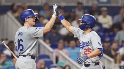 Los Angeles Dodgers' Tommy Edman (25) celebrates his two-run home run with Will Smith (16) during the fourth inning of a baseball game against the Miami Marlins, Wednesday, Sept. 18, 2024, in Miami. (AP Photo/Marta Lavandier)