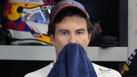 Red Bull driver Sergio Perez of Mexico wipes his sweat inside their garage during the second practice session of the Singapore Formula One Grand Prix at the Marina Bay Street Circuit, in Singapore, Friday, Sept. 20, 2024. (AP Photo/Vincent Thian)
