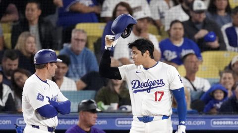 Los Angeles Dodgers' Shohei Ohtani gestures toward the Dodger bullpen after hitting a single during the seventh inning of a baseball game against the Colorado Rockies, Friday, Sept. 20, 2024, in Los Angeles. (AP Photo/Mark J. Terrill)