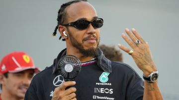 Mercedes driver Lewis Hamilton of Britain gestures during he drivers parade ahead of the Singapore Formula One Grand Prix at the Marina Bay Street Circuit, in Singapore, Sunday, Sept. 22, 2024. (AP Photo/Vincent Thian)