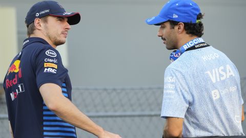 Red Bull driver Max Verstappen, left, of the Netherlands and RB driver Daniel Ricciardo of Australia talk during the drivers parade ahead of the Singapore Formula One Grand Prix at the Marina Bay Street Circuit, in Singapore, Sunday, Sept. 22, 2024. (AP Photo/Vincent Thian)