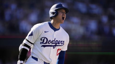 Los Angeles Dodgers' Shohei Ohtani celebrates as he heads to first for a solo home run during the ninth inning of a baseball game against the Colorado Rockies, Sunday, Sept. 22, 2024, in Los Angeles. (AP Photo/Mark J. Terrill)