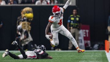 Kansas City Chiefs wide receiver Rashee Rice (4) leaps around Atlanta Falcons cornerback Mike Hughes (21) during the first half of an NFL football game, Sunday, Sept. 22, 2024, in Atlanta. The Chiefs defeated the Falcons 22-17. (AP Photo/Danny Karnik)