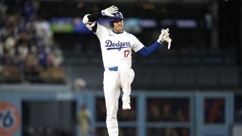 Los Angeles Dodgers' Shohei Ohtani gestures toward his dugout after hitting a double during the first inning of a baseball game against the San Diego Padres, Tuesday, Sept. 24, 2024, in Los Angeles. (AP Photo/Mark J. Terrill)