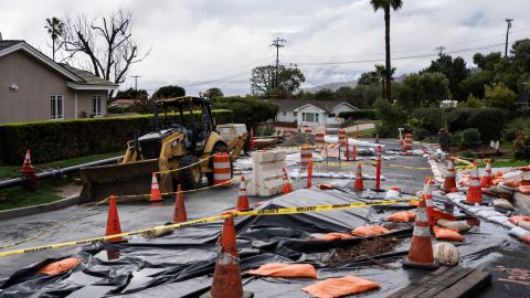 Caution tape closes off streets due to land movement intensified by recent storms in Rancho Palos Verdes, Calif., Tuesday, Feb. 20, 2024. Much of saturated California remains under threat of floods as the latest winter storm blows through, but so far the state has escaped the severity of damage spawned by a recent atmospheric river. (AP Photo/Jae C. Hong)