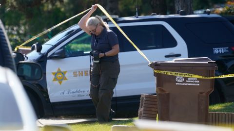 A forensic investigator leaves the home of Bishop David O'Connell in Hacienda Heights, Calif., Sunday, Feb. 19, 2023. O'Connell was shot and killed Saturday just blocks from a church, a slaying of a longtime priest hailed as a “peacemaker” that's stunned the Los Angeles religious community, authorities said. Detectives are investigating the death as a homicide, according to the Los Angeles County Sheriff's Department. (AP Photo/Damian Dovarganes)