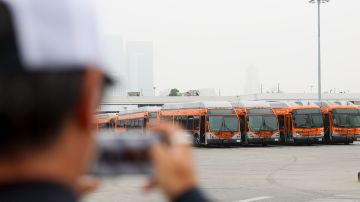 News media prepare to go live in front of a Los Angeles MTA bus depot near the site where overnight a bus was hijacked by an armed subject with passengers on board Wednesday, Sept. 25, 2024, in Los Angeles. One person was fatally shot before police apprehended the suspect. (AP Photo/Ryan Sun)