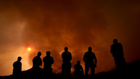 Firefighters monitor the advancing Line Fire in Angelus Oaks, Calif., Monday, Sept. 9, 2024. (AP Photo/Eric Thayer)