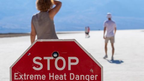 FILE - A person wipes sweat from their brow at Badwater Basin in Death Valley National Park, Calif., July 7, 2024. (AP Photo/Ty ONeil, File)