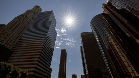 The sun shines over the financial district towers of downtown Los Angeles during a heatwave Friday, Sept. 6, 2024, in Los Angeles. (AP Photo/Etienne Laurent)