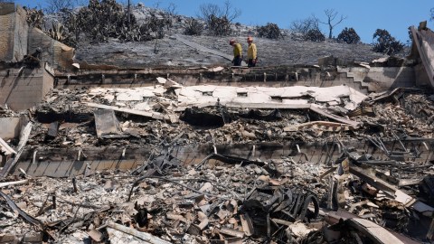 Fire crews examine a property damaged by the Airport Fire Thursday, Sept. 12, 2024, in El Cariso Village, in unincorporated Riverside County, Calif. (AP Photo/Gregory Bull)
