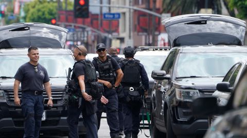 Los Angeles Police Department Special Weapons and Tactics (SWAT) team members leave following an hours-long standoff after a man fired a gun inside his apartment before barricading himself inside, Sunday, July 31, 2022, in the Hollywood district of Los Angeles. Officers responded around 7:30 a.m. to reports of gunfire on a residential block near the farmers market where vendors set up stalls every Sunday morning. Police closed several surrounding streets and shut down the market out of abundance of caution. (AP Photo/Damian Dovarganes)