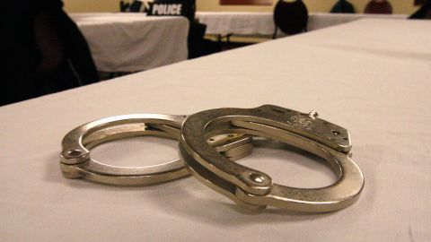 Handcuffs used on men arrested for prostitution solicitation sit on a table at a hotel in Minot, N.D., on Saturday, Jan. 31, 2015. Sex trafficking has become a big problem in North Dakota amid an oil boom that has brought in money and oil workers. The Minot police sting ended with the arrests of 13 men, who answered ads on an escort website posted by the undercover officers. (AP Photo/Martha Irvine)