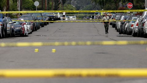 A Santa Barbara County deputy sheriff walks along the street near the scene of a shooting on Saturday, May 24, 2014, in Isla Vista, Calif. A drive-by shooter went on a rampage near a Santa Barbara university campus that left seven people dead, including the attacker, and others wounded, authorities said Saturday. (AP Photo/Jae C. Hong)