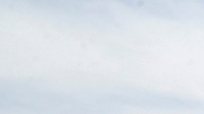 FILE - In this July 7, 2019 file photo, a visitor takes a photo of a crack in the ground following recent earthquakes near Ridgecrest, Calif. The Naval Air Weapons Station China Lake military base nearby remains closed to non-essential personnel as damage assessments continue following last week's powerful earthquakes in the area. (AP Photo/Marcio Jose Sanchez, File)