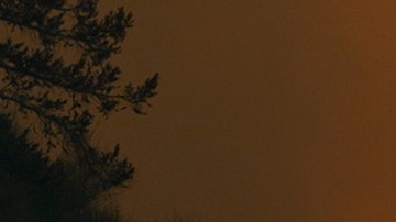 The Line Fire jumps highway 330 as an emergency vehicle is driven past Saturday, Sept. 7, 2024, near Running Springs, Calif. (AP Photo/Eric Thayer)