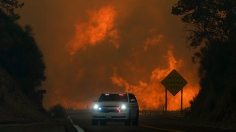 The Line Fire jumps highway 330 as an emergency vehicle is driven past Saturday, Sept. 7, 2024, near Running Springs, Calif. (AP Photo/Eric Thayer)