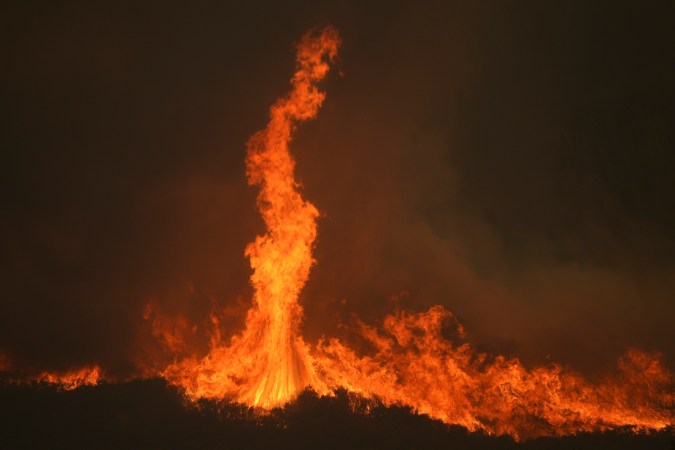The Airport Fire burns on a mountain top Tuesday, Sept. 10, 2024, in El Cariso, an unincorporated community in Riverside County, Calif. (AP Photo/Eric Thayer)