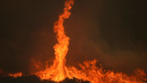 The Airport Fire burns on a mountain top Tuesday, Sept. 10, 2024, in El Cariso, an unincorporated community in Riverside County, Calif. (AP Photo/Eric Thayer)