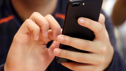 FILE - In this Sept. 16, 2017, file photo, a person uses a smart phone in Chicago. Bank impersonations are the top reported type of text message scam. Learn what to look out for so you can avoid bank-impersonation scams and keep your money safe. (AP Photo, File)