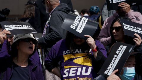 People hold up signs in support of a proposed robotaxi expansion as they wait to enter the Public Utilities Commission building on Thursday, Aug. 10, 2023, in San Francisco. (AP Photo/Godofredo A. Vásquez)