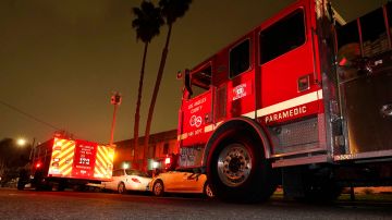 Los Angeles County Fire Department vehicles sit at a medical call Friday, Jan. 7, 2022, in Inglewood, Calif. Occasionally, firefighters transport patients to the hospital in fire engines because of short staffing amid an explosion in omicron-fueled coronavirus infections at an ambulance company that the fire department contracts with. (AP Photo/Mark J. Terrill)