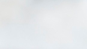 A surfer rests on his board as a jogger passes on Wednesday, May 13, 2020, in Manhattan Beach, Calif. Los Angeles County reopened its beaches Wednesday in the latest cautious easing of coronavirus restrictions that have closed most California public spaces and businesses for nearly two months. (AP Photo/Ashley Landis)