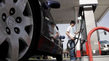 A motorist fuels up at a gas station in Santa Cruz, Calif., Monday, March 7, 2011. Pump prices have jumped an average of 39 cents per gallon since the Libyan uprising began in mid-February, forcing motorists to pay an additional $146 million per day for the same amount of fuel. (AP Photo/Marcio Jose Sanchez)