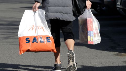 A shopper leaves a supermarket with goods in plastic bags in Christchurch, New Zealand, Friday, Aug. 10, 2018. New Zealand plans to ban disposable plastic shopping bags by next July as the nation tries to live up to its clean-and-green image. Prime Minister Jacinda Ardern said Friday that New Zealanders use hundreds of millions of the bags each year and that some of them end up polluting the precious coastal and marine environment. (AP Photo/Mark Baker)