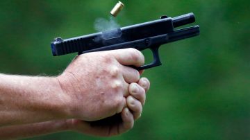 In this April 30, 2016 photograph, a spent round is ejected through gun smoke from a participant's cautomatic handgun during the live fire portion of a enhanced concealed carry class sponsored by Crestview Baptist Church for members and area residents in Petal, Miss. The 20 participants received hands on assistance during a practical shooting exercise, a thorough review on the fundamentals of safe handling of firearms in addition to a review of the basic and enhanced Mississippi Concealed Carry laws. (AP Photo/Rogelio V. Solis)