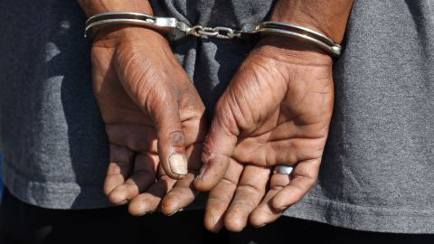 A man is handcuffed during a crackdown on crime near an overcrowded downtown homeless shelter plagued by drugs and violence Monday, Aug. 14, 2017, In Salt Lake City. The area has long been a hotbed of criminal activity but recently made headlines with a string of violent crimes, capturing the attention of House Speaker Greg Hughes and Utah Gov. Gary Herbert. (AP Photo/Rick Bowmer)