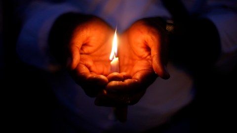 An Indian Christian holds a candle in solidarity with the victims of Sundays suicide attack on a church in Pakistan, outside the Sacred Heart Cathedral in New Delhi, India, Tuesday, Sept. 24, 2013. The attack left 85 people dead and more than 140 people wounded. It was the deadliest ever attack in Pakistan against members of the Christian faith. (AP Photo/Altaf Qadri)