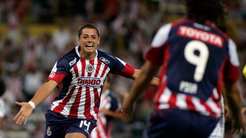 FILE - In this April 4, 2009 file photo, Chivas' Javier Hernandez, left, celebrates his goal against San Luis at a Mexican league soccer match in Guadalajara, Mexico. Manchester United will sign its first Mexican player after agreeing to take striker Javier Hernandez from Chivas for next season. (AP Photo/Ricardo Arduengo, File)