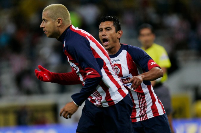 Chivas' Adolfo Bautista, left, celebrates with Chivas? Alberto Medina after scoring a goal against Puebla's soccer team during their Mexican league soccer match in Guadalajara, Mexico, Saturday Feb. 20, 2010. (AP Photo/Carlos Jasso)