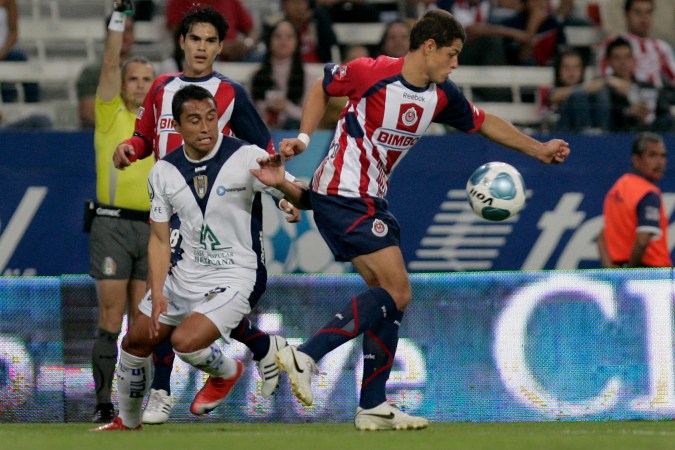San Luis' Edwin Hernandez, left, fights for the ball with Chivas' Javier Hernandez, right, during a Mexican league soccer match in Guadalajara, Mexico, Saturday, Feb. 27, 2010. (AP Photo/Carlos Jasso)