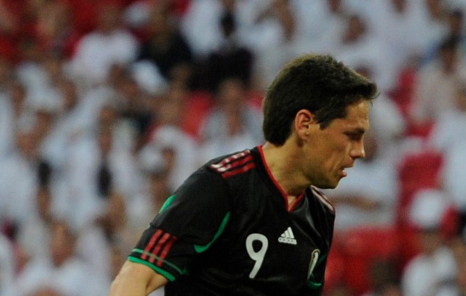 Mexico's Guillermo Franco, left, shoots and scores a goal as England's Leighton Baines reacts, right, during their international soccer friendly match at Wembley stadium in London, Monday, May 24, 2010. Both England and Mexico have qualified for the World Cup in South Africa 2010, and are playing a series of friendlies in preparation for the competition. (AP Photo/Tom Hevezi)