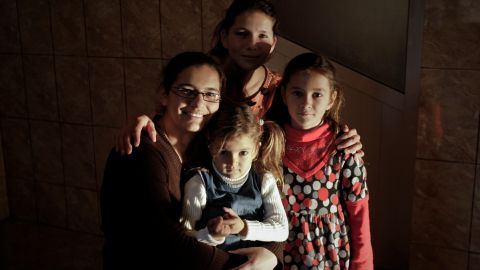 In this Nov. 25, 2010 picture, Narcisa Tranca, 22, top, poses with her sister Claudia, 18, left, and two of her children in Udupu, Romania. Among Gypsies, or Roma, marrying young is a tradition born of the need to survive in an environment where young women were fair game for non-Roma men. Romanian Roma, in particular, turned to early marriage during 500 years of slavery that ended only in the 19th century. (AP Photo/Vadim Ghirda)